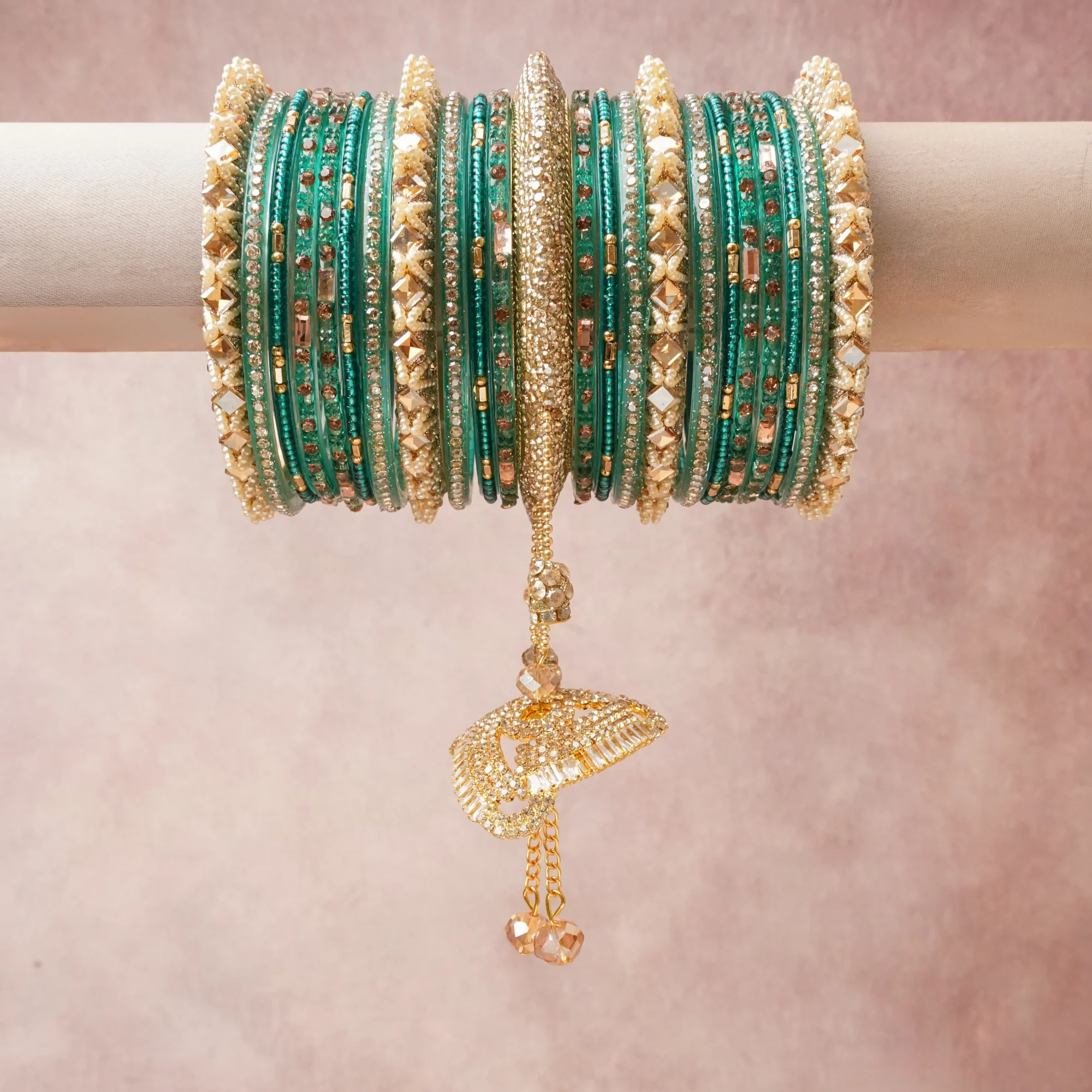 A commanding teal green anchors this beautiful set, enriched with accents of gold, champagne, ivory that add depth and dimension.

Featuring a striking composition of crystal beads, glass beads, gold-tone metal, this set carries intricate craftsmanship and strong presence. Grand in form, it is created for moments that deserve to be marked.