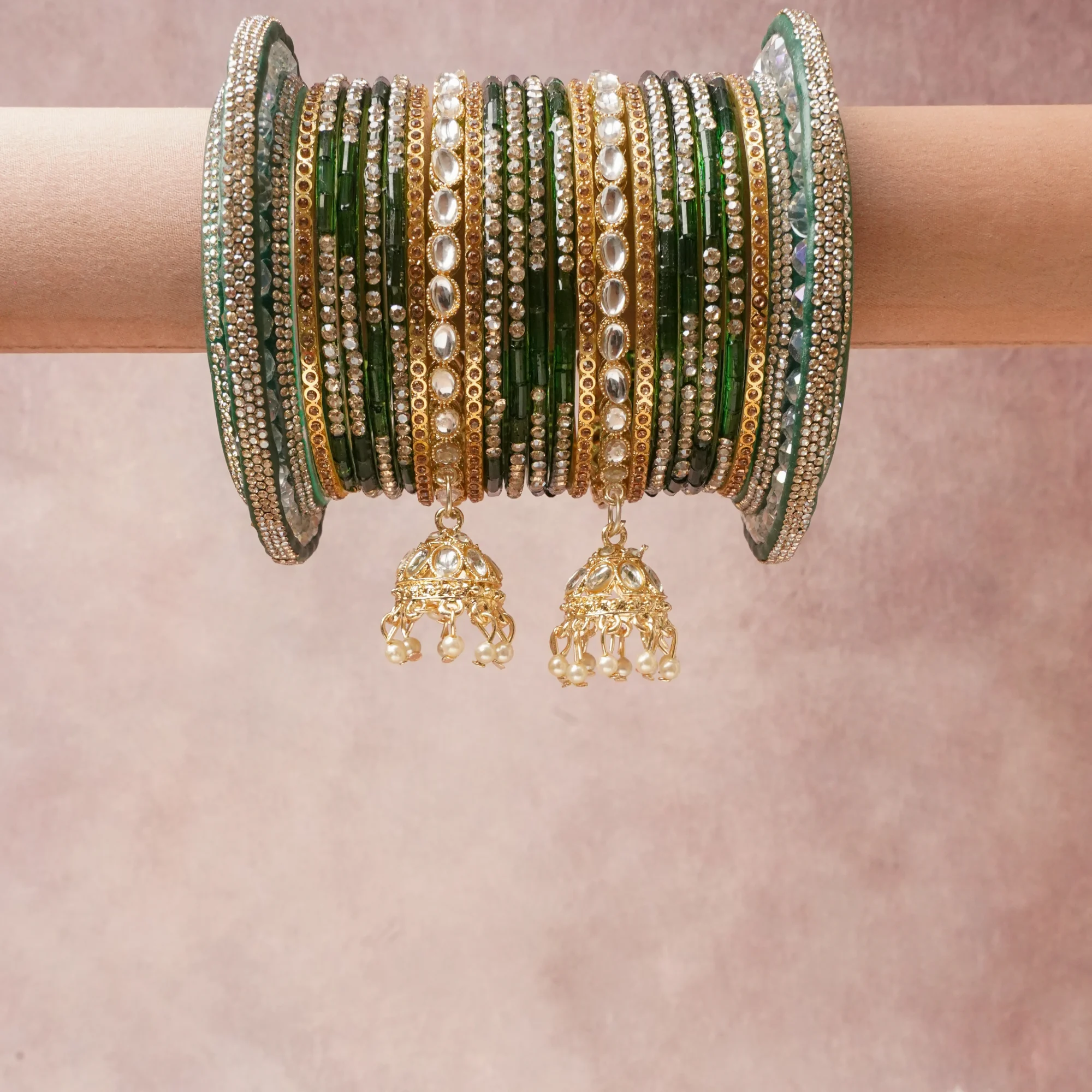 A commanding Emerald Green anchors this beautiful set, enriched with accents of Gold that add depth and dimension.

Featuring a striking composition of glass bangles, rhinestone, gold-tone metal, pearls, this set carries intricate craftsmanship and strong presence. Grand in form, it is created for moments that deserve to be marked.