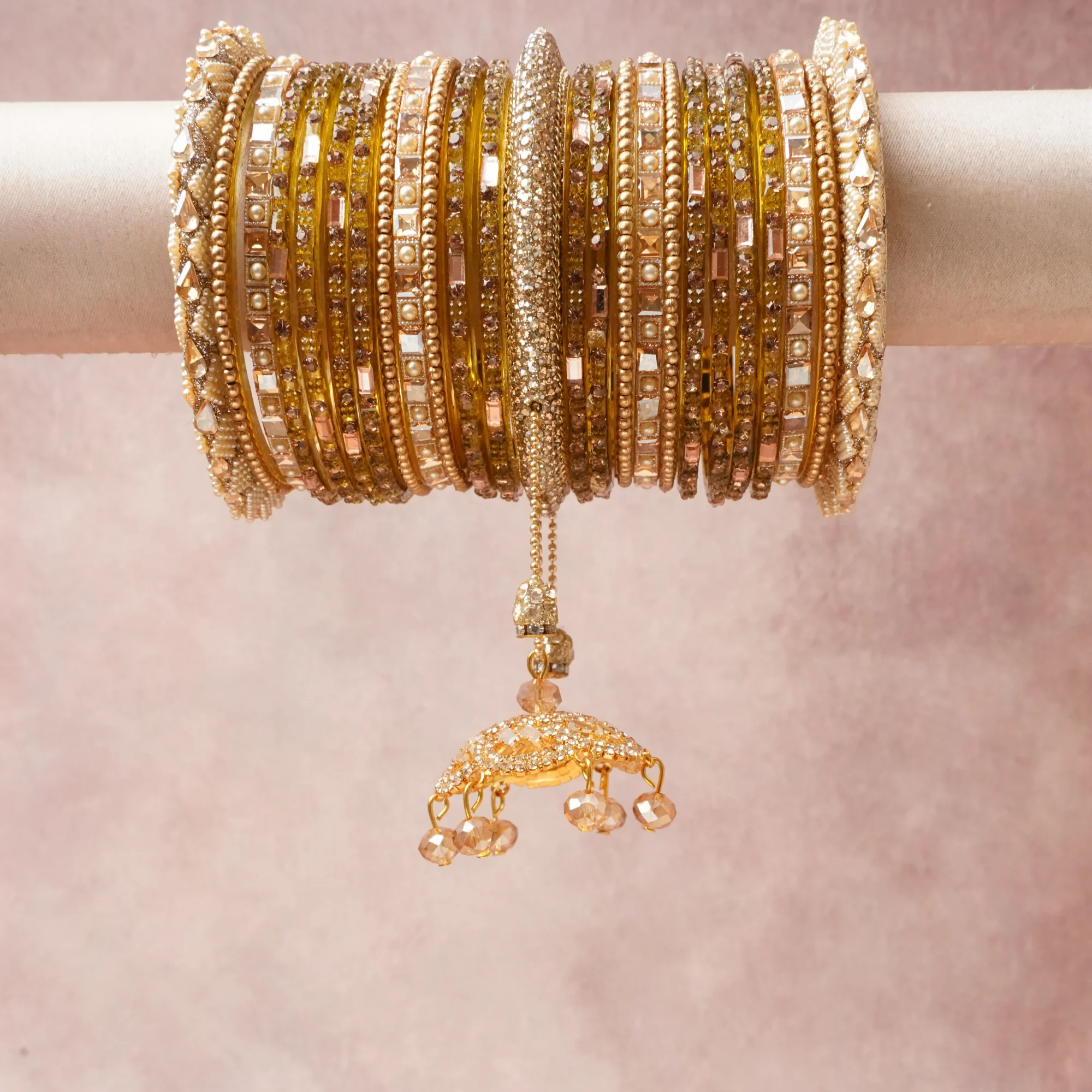 A commanding Gold anchors this beautiful set, enriched with accents of Champagne that add depth and dimension.

Featuring a striking composition of Gold-tone metal, Kundan stones, crystal beads, this set carries intricate craftsmanship and strong presence. Grand in form, it is created for moments that deserve to be marked.