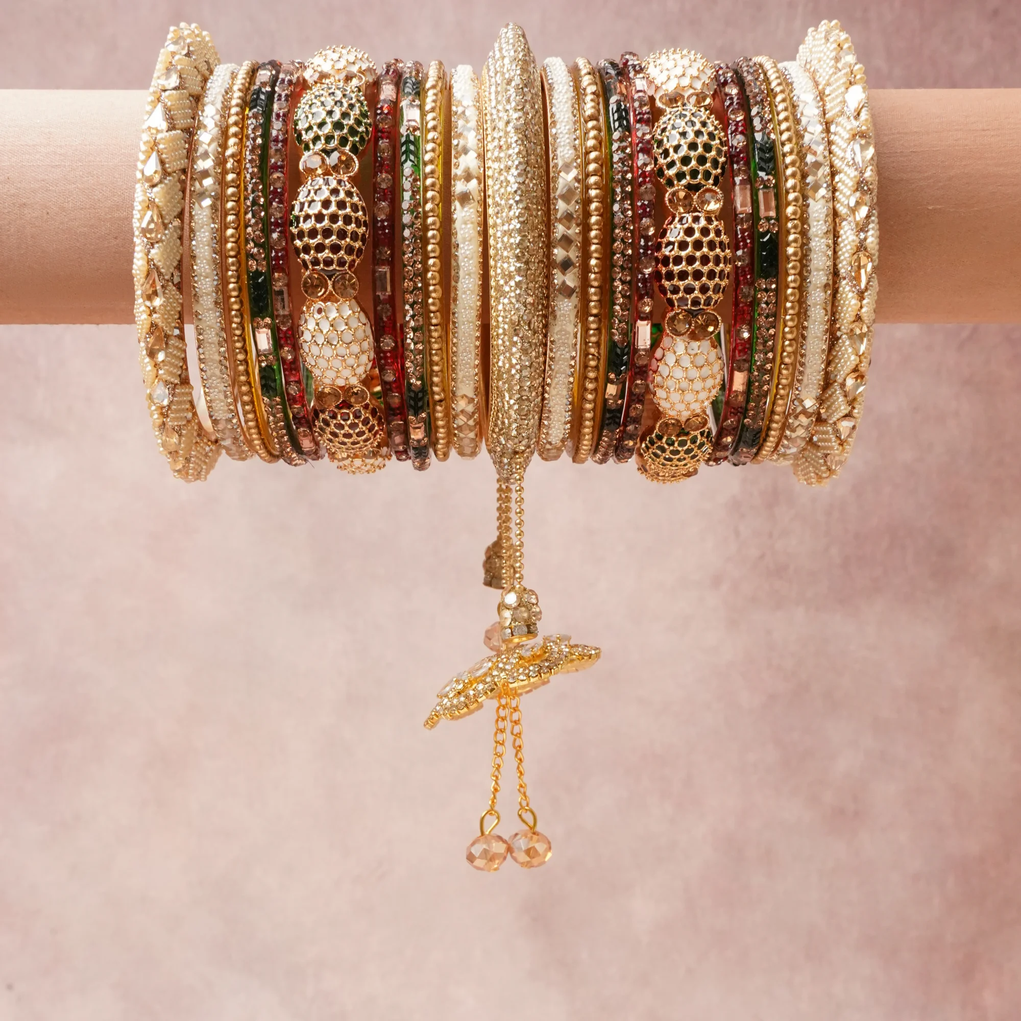 A commanding gold anchors this beautiful set, enriched with accents of ivory, rose gold, emerald green that add depth and dimension.

Featuring a striking composition of metal, crystal, stone beads, this set carries intricate craftsmanship and strong presence. Grand in form, it is created for moments that deserve to be marked.