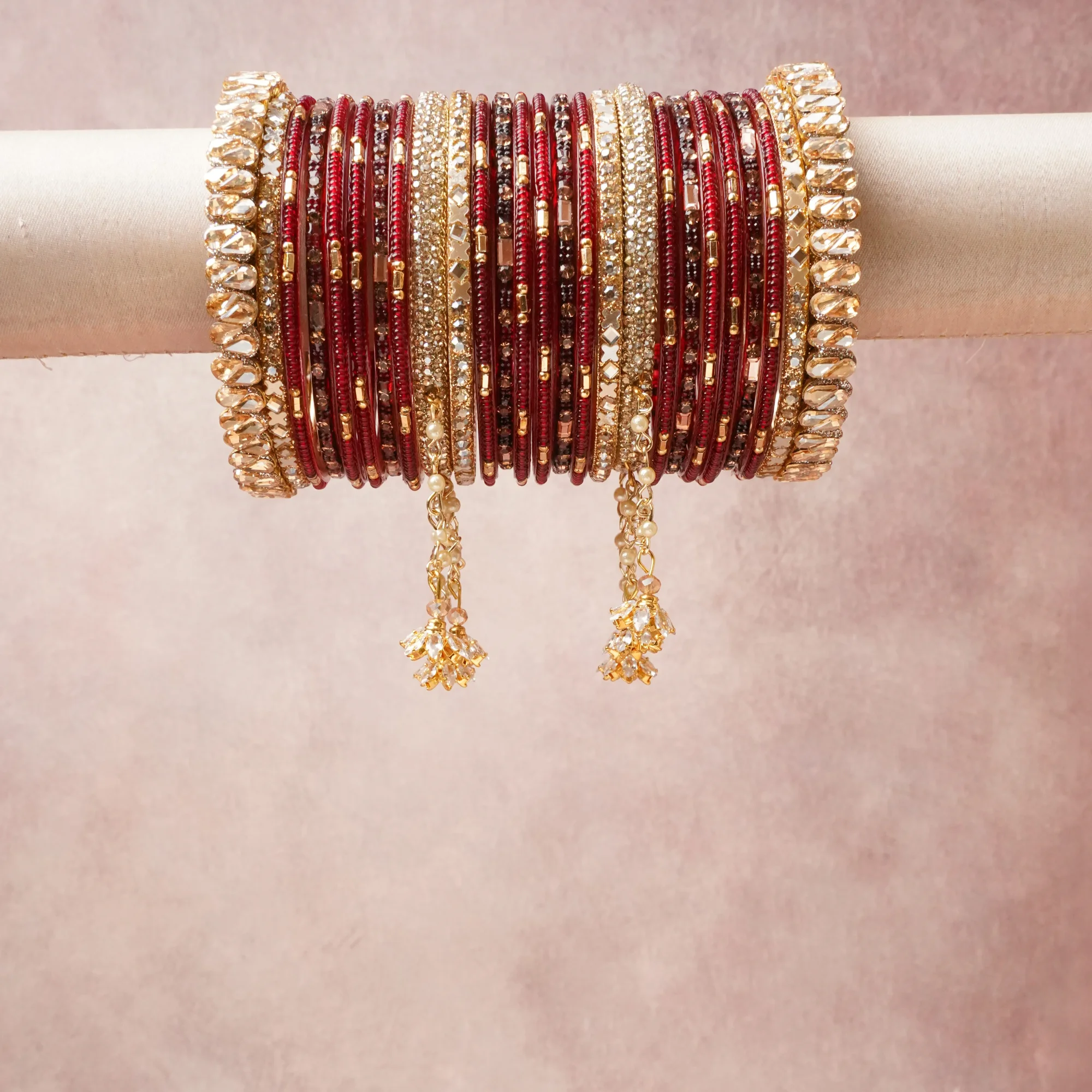 A commanding red anchors this beautiful set, enriched with accents of gold, champagne that add depth and dimension.

Featuring a striking composition of glass bangles, gold-tone metal, rhinestones, this set carries intricate craftsmanship and strong presence. Grand in form, it is created for moments that deserve to be marked.
