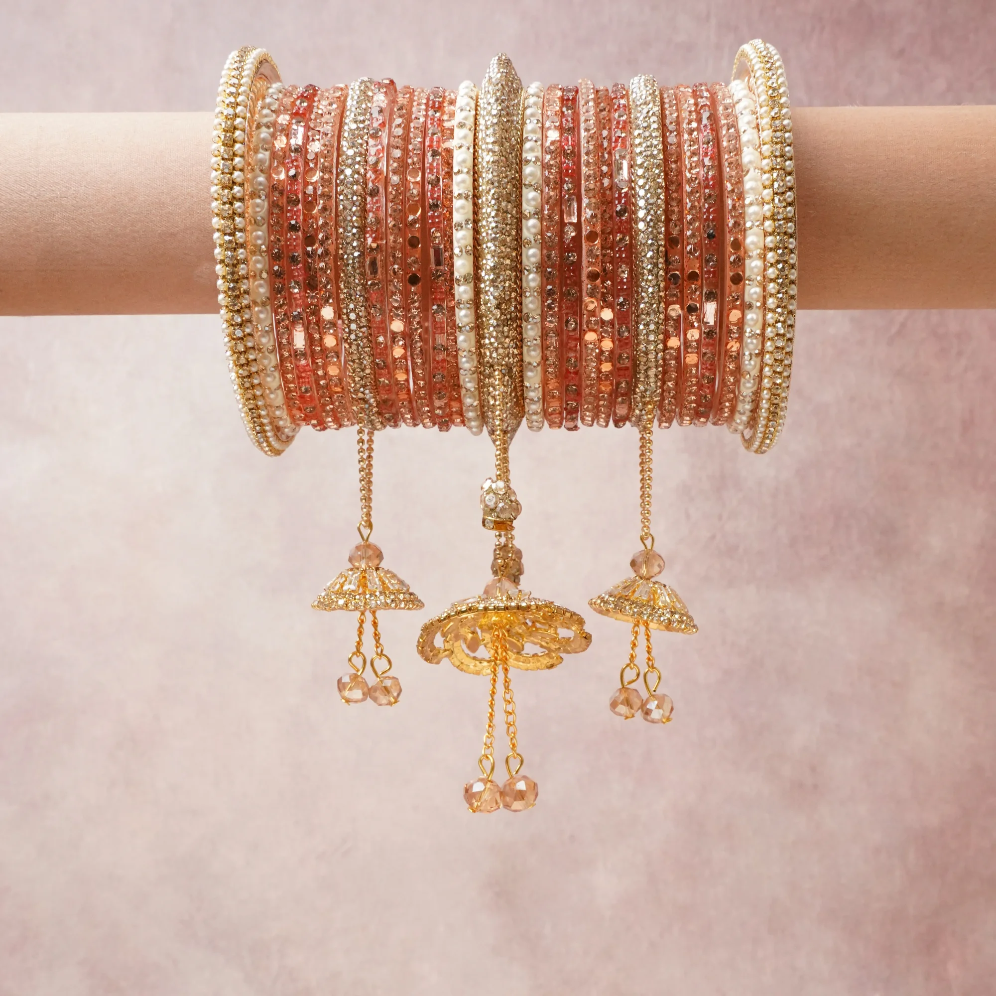 A commanding blush peach anchors this beautiful set, enriched with accents of gold, rose gold, ivory that add depth and dimension.

Featuring a striking composition of crystal-studded metal, this set carries intricate craftsmanship and strong presence. Grand in form, it is created for moments that deserve to be marked.
